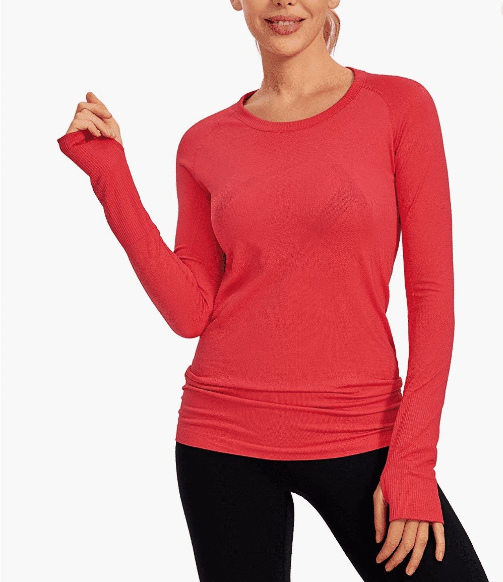 Girl modeling a red long sleeve athletic top and black leggings.