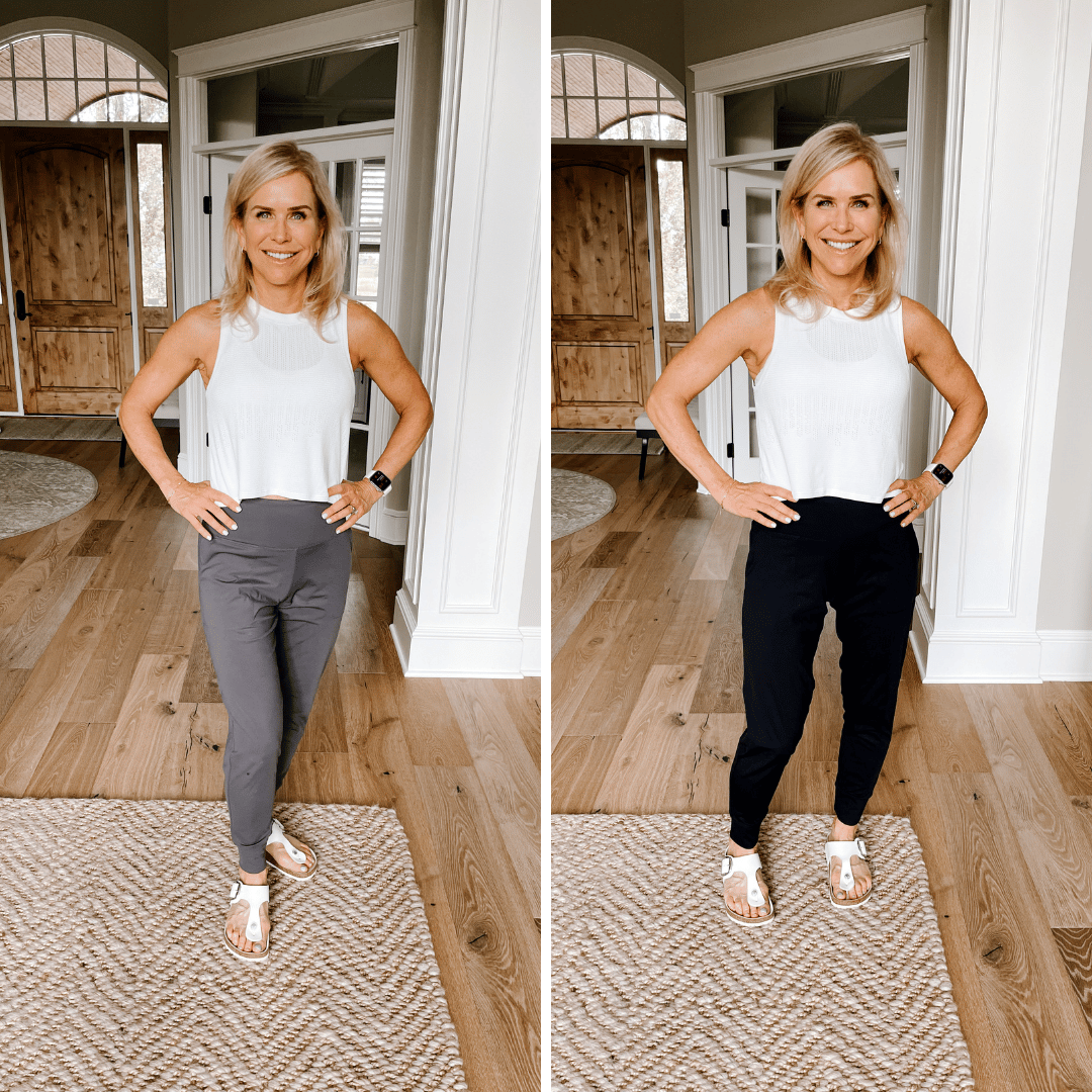 Chris Freytag posing in a white tank top and grey joggers and black joggers in the front entry way. Showing off her outfit.
