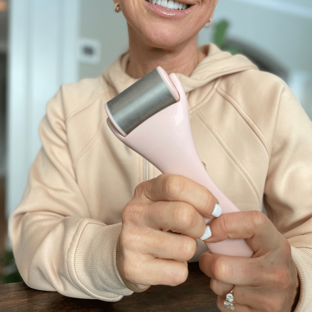 Chris Freytag holding an ice roller as one of the best skin care products for women over 50