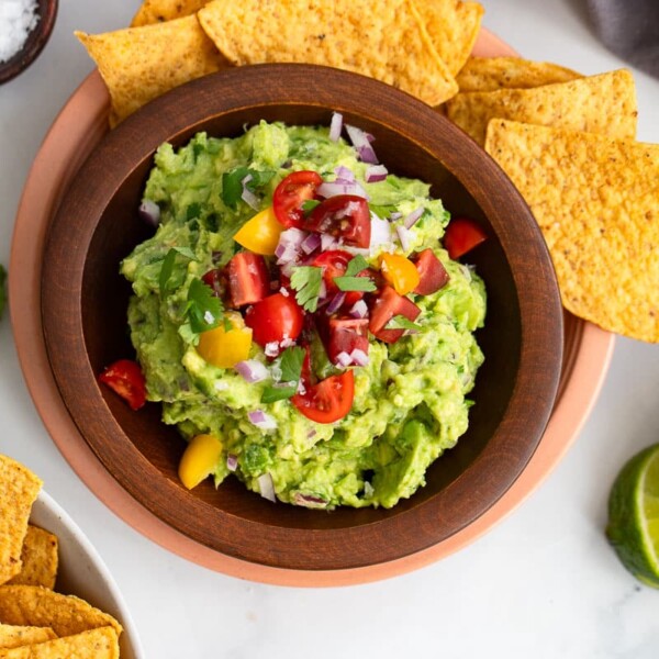 bowl of health homemade guacamole with chips on the side