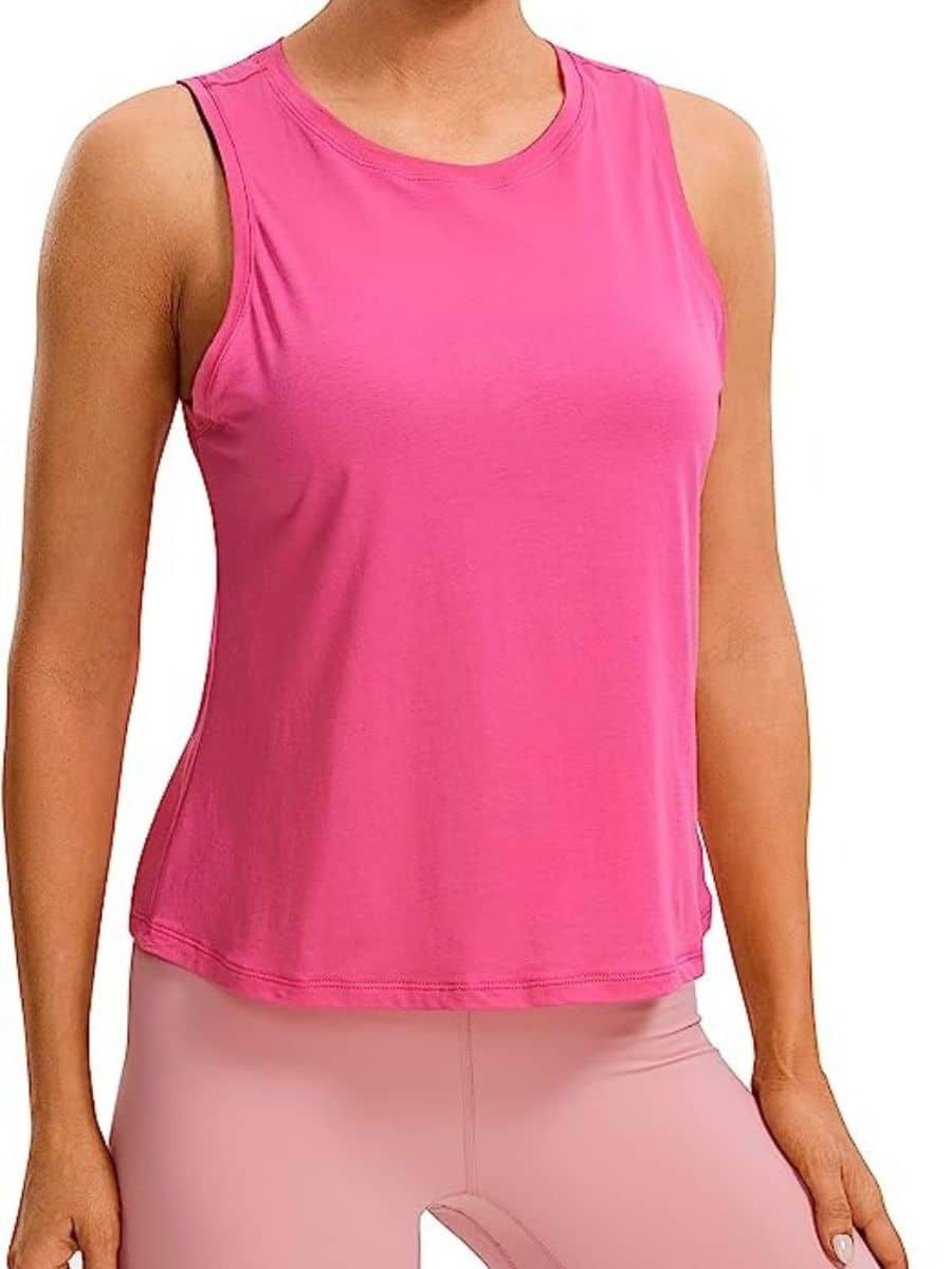 A person wearing a pink CRZ YOGA Pima cotton cropped tank top.
