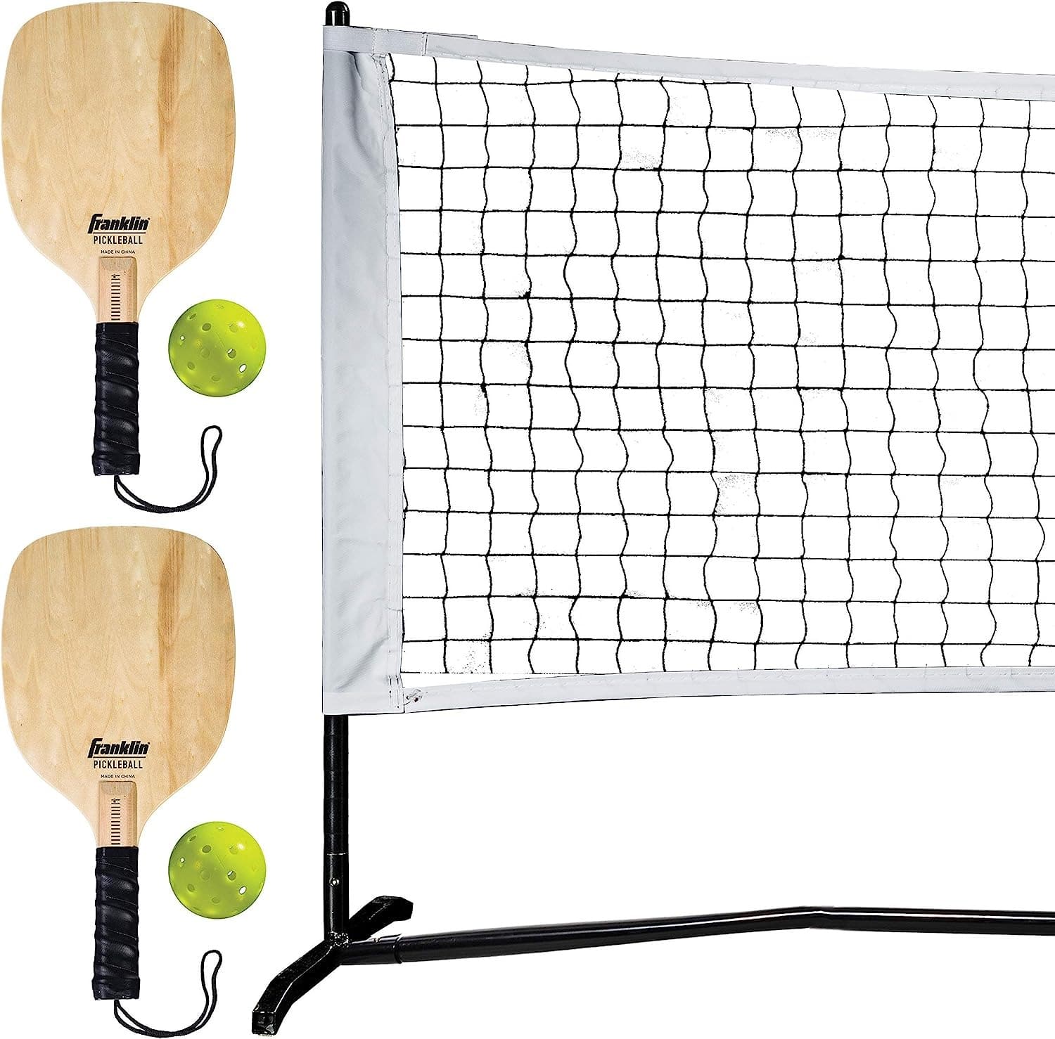 Two wooden pickleball paddles and balls next to the Franklin Sports pickleball net.