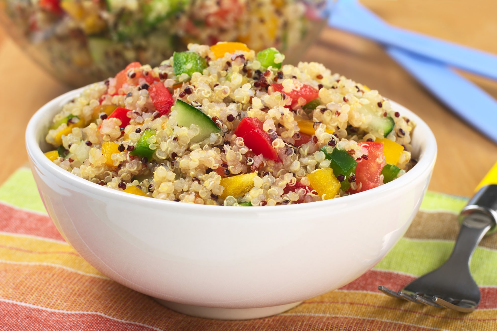 Vegetarian quinoa salad with bell pepper, cucumber and tomatoes.