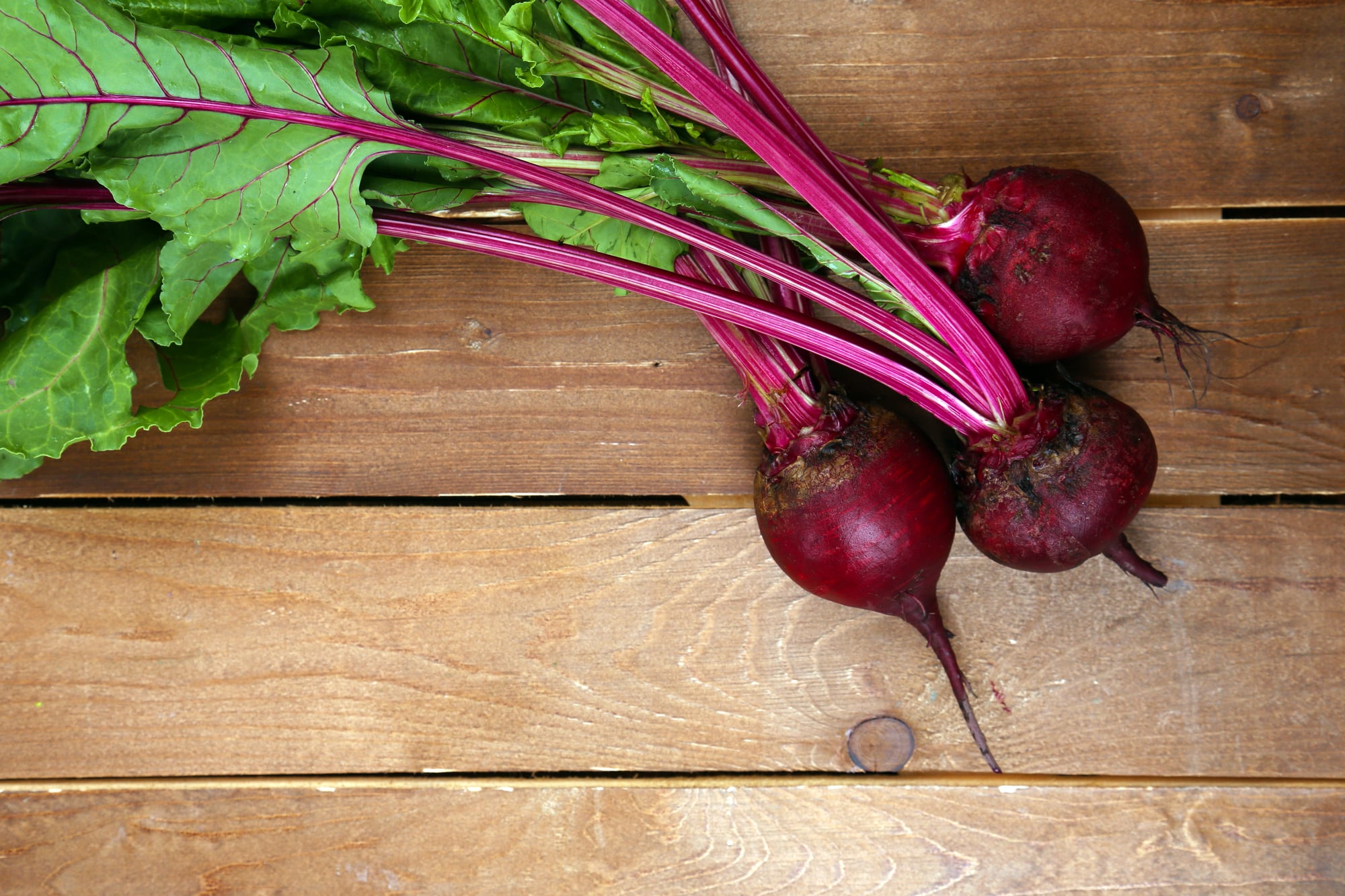 Young beets on a wooden table.