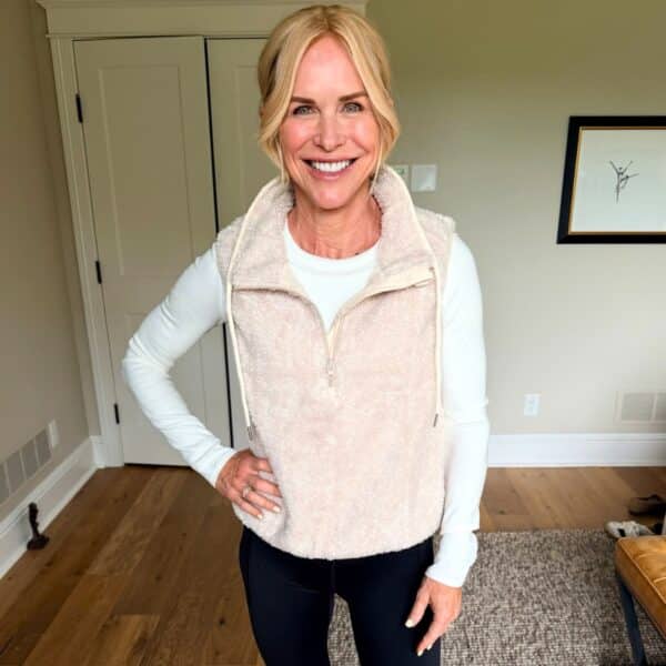Woman over 40 doing cozy cardio on a walking pad in a softly lit living room