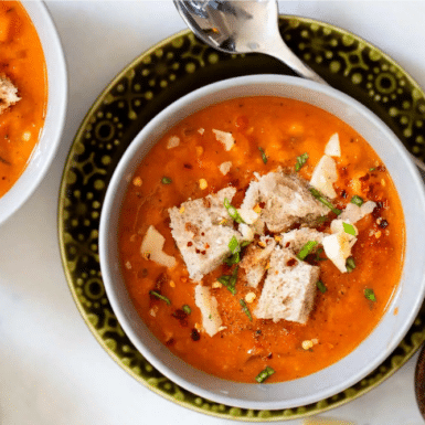 A close up of creamy, colorful Tuscan soup.