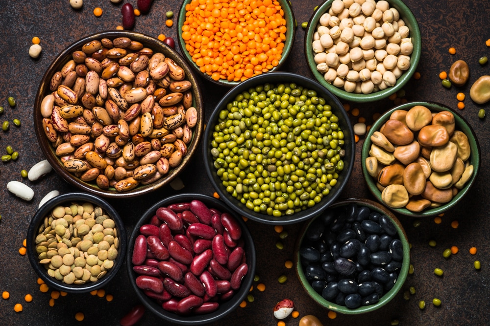 Legumes, lentils, chikpea and beans assortment successful  antithetic  bowls connected  chromatic  table.