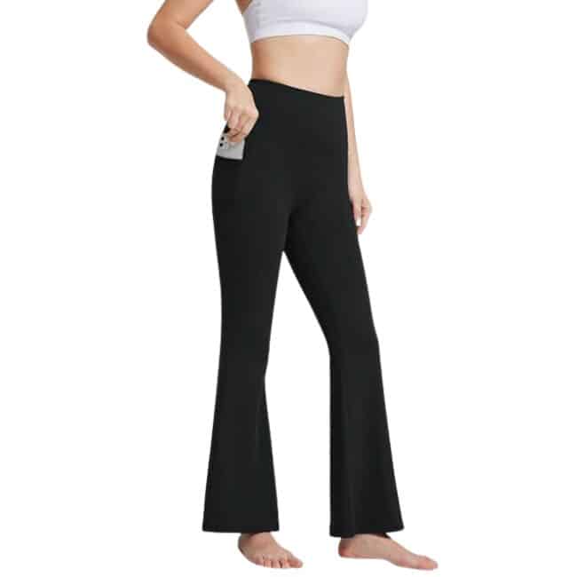 bottom half of woman wearing black flare leggings with pocket for phone and white sports bra
