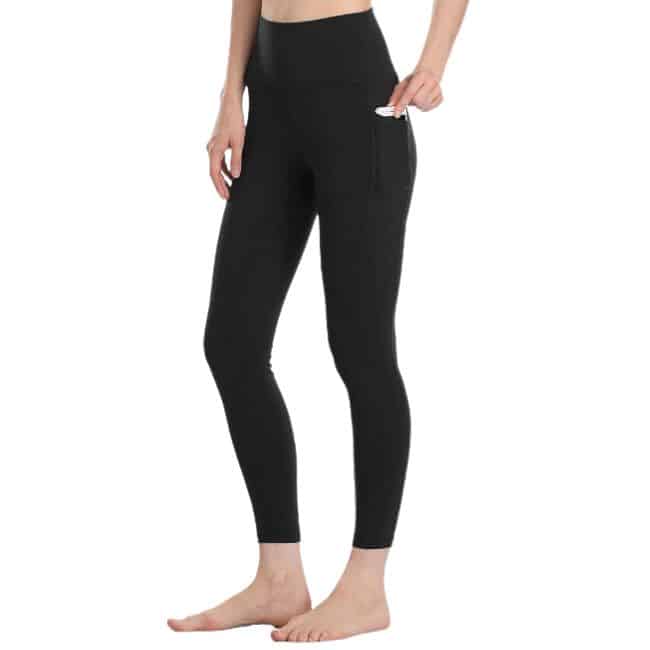 bottom half of woman wearing black leggings barefoot