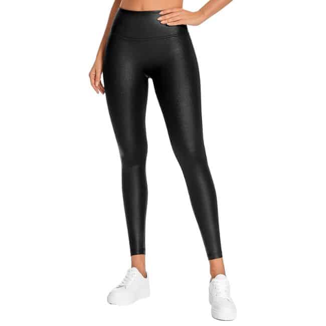 bottom half of woman wearing black faux leather leggings and white tennis shoes