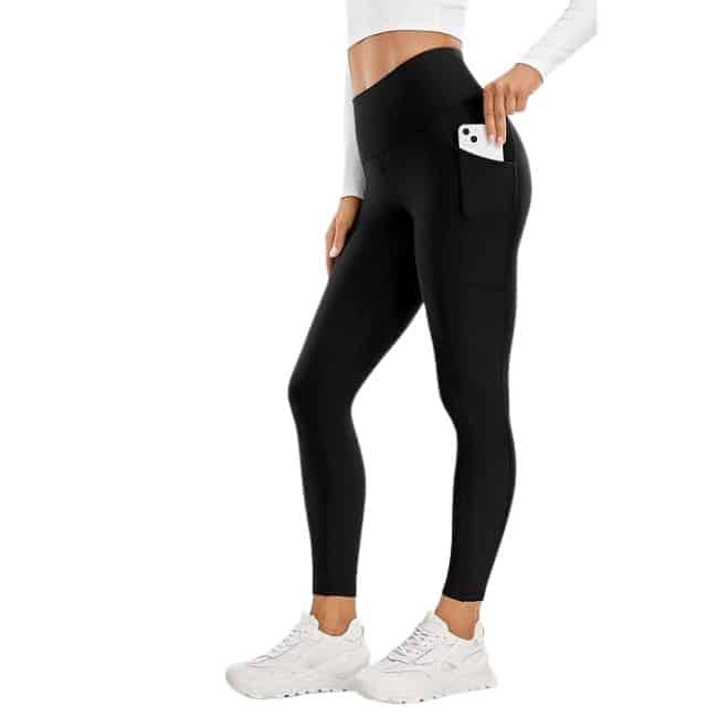 lower half of woman wearing black thermal leggings with pocket and white tennis shoes
