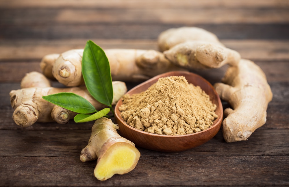 Ginger basal   and a vessel  of ginger powder.