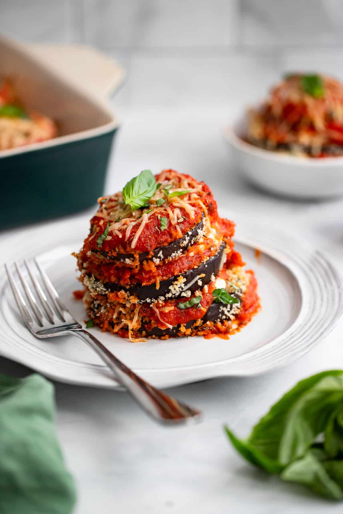 up close image of healthy eggplant parmesan plated with fork