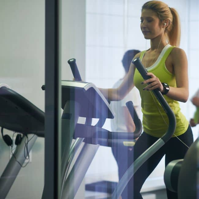 woman using elliptical machine for cardio weight loss