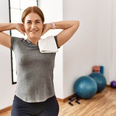 woman happy exercising doing back pain stretches