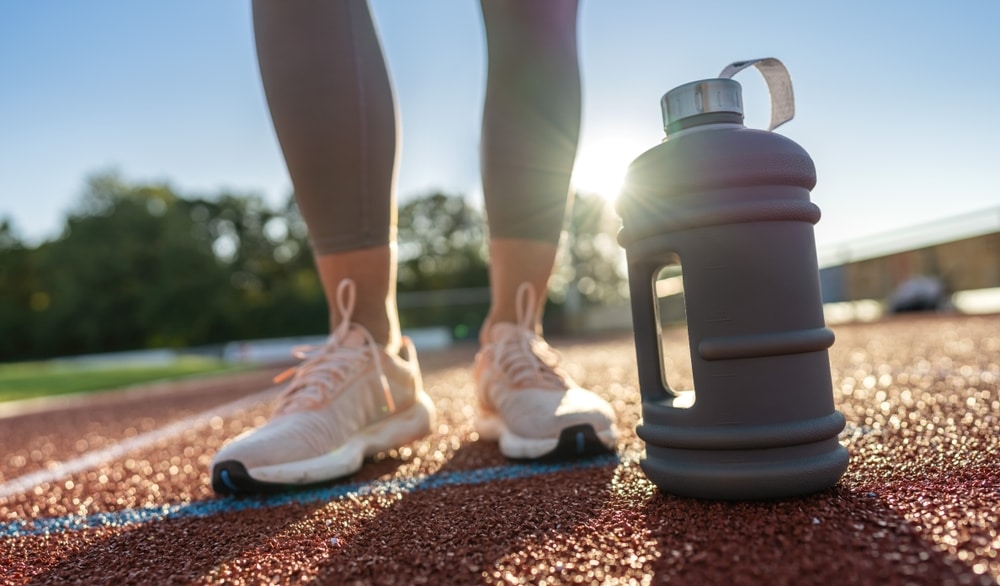 woman ready to walk on track with jug of water