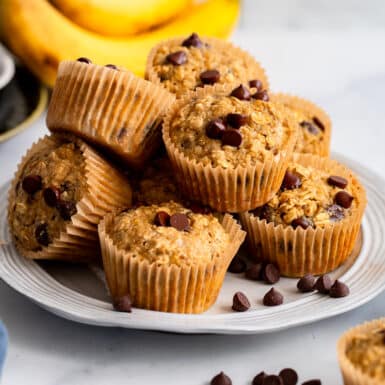 healthy oat flour banana muffins piled on plate