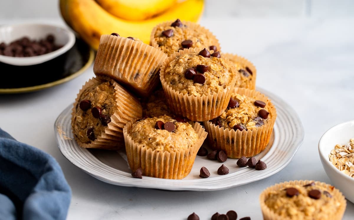 healthy oat flour banana muffins piled on plate