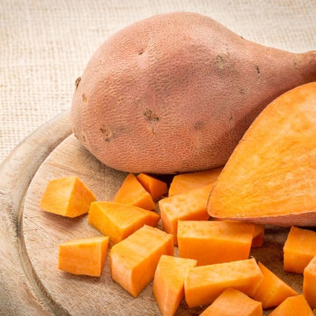 raw sweet potato cut as one of best foods that lower cholesterol