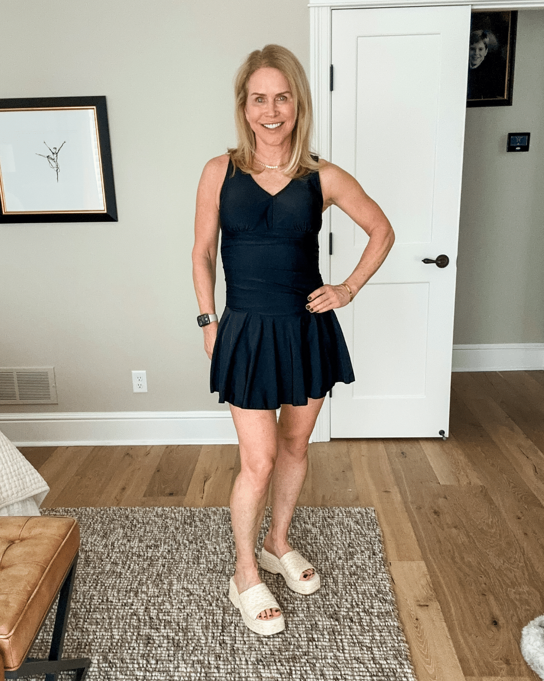 Chris Freytag wearing a full coverage woebegone swim suit for women over 50. One piece coverage with a skirt tying to it. 