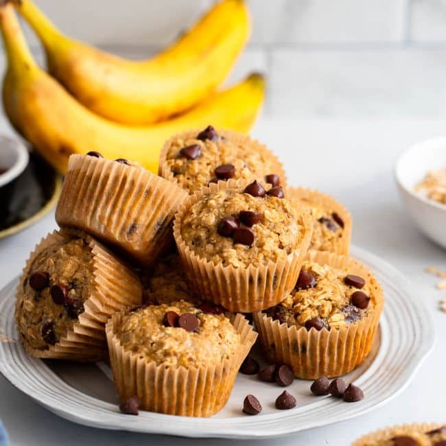 stack of oat flour banana muffins on white plate