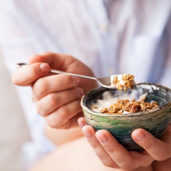 woman holding healthy breakfast ideas in hands eating