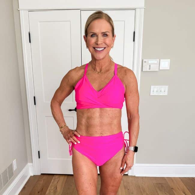 woman wearing bright pink two piece swimsuit with adjustable ties