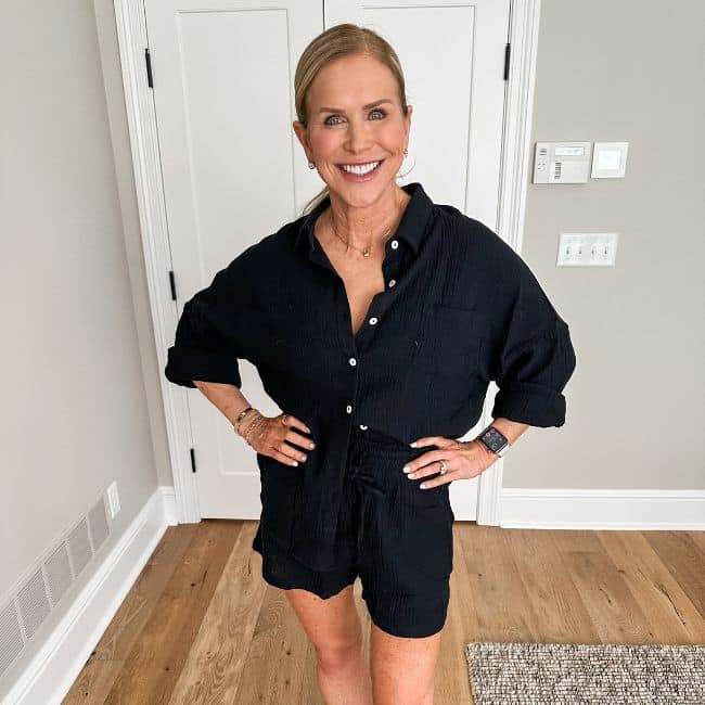 woman wearing two piece black linen shorts and shirt cover up smiling