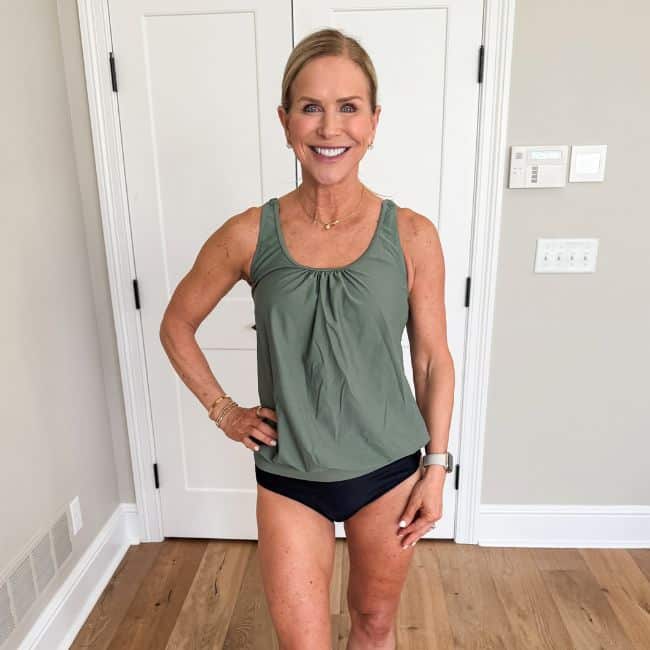 woman wearing two piece blouson tankini in green and black swimsuit