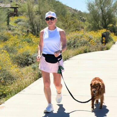 woman power walking on path with dog