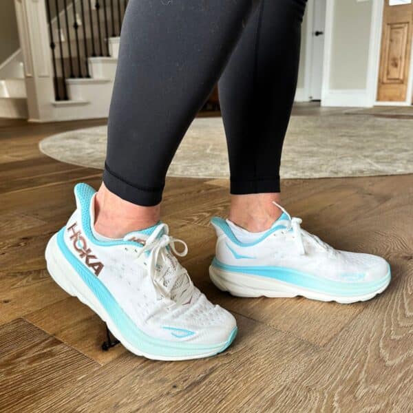 personal trainer showing best walking shoes as hoka clifton 9