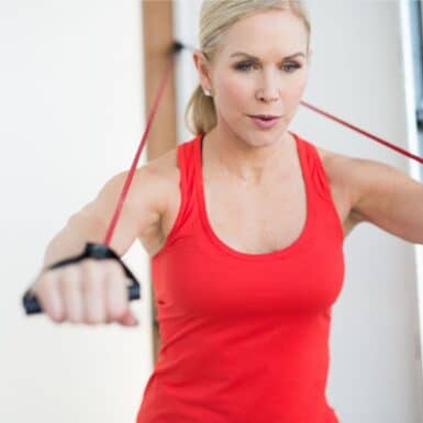 woman performing exercise with resistance band