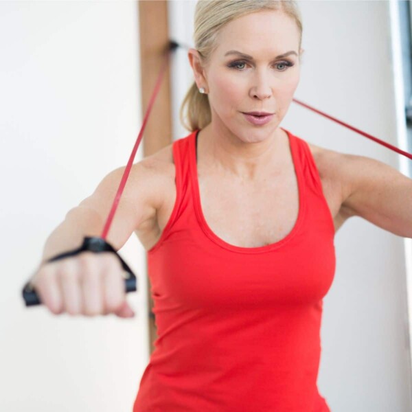 woman performing exercise with resistance band