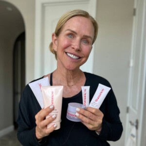 woman holding best skin care products for women over 50