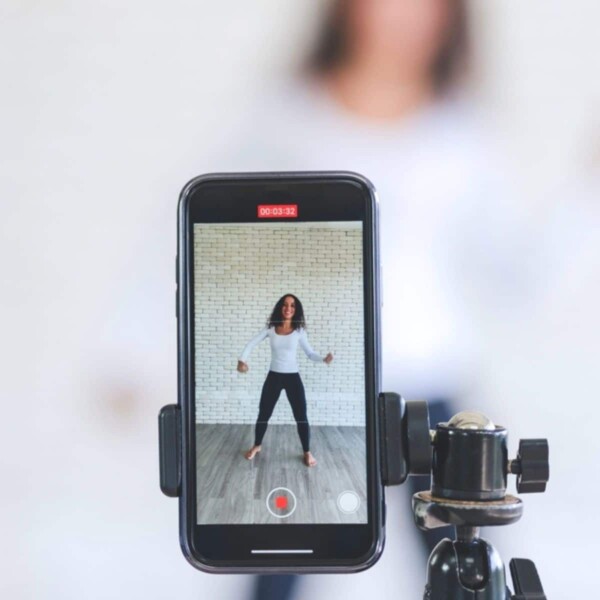 woman working out on phone while recording