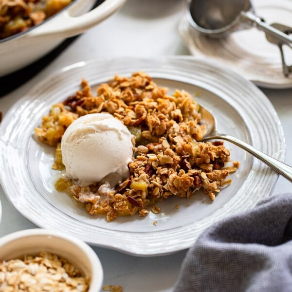 rhubarb crisp served on plate with vanilla ice cream