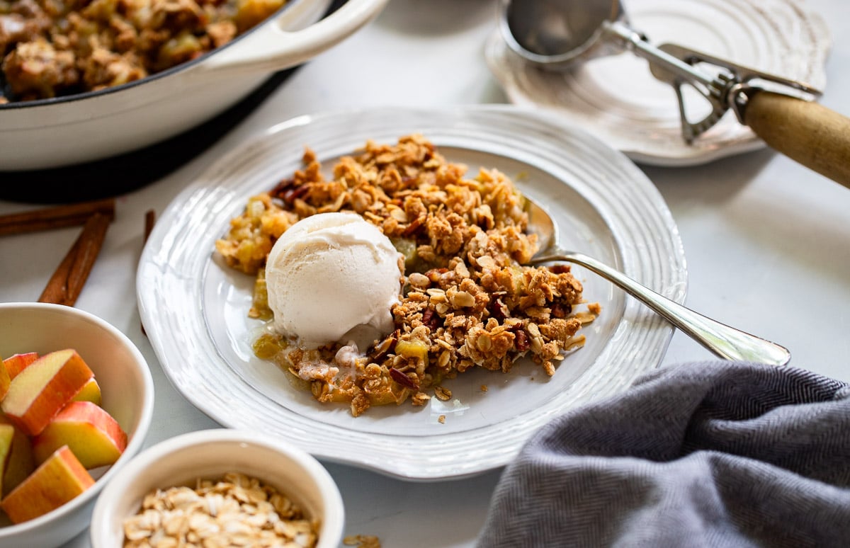 rhubarb crisp served on plate with vanilla ice cream