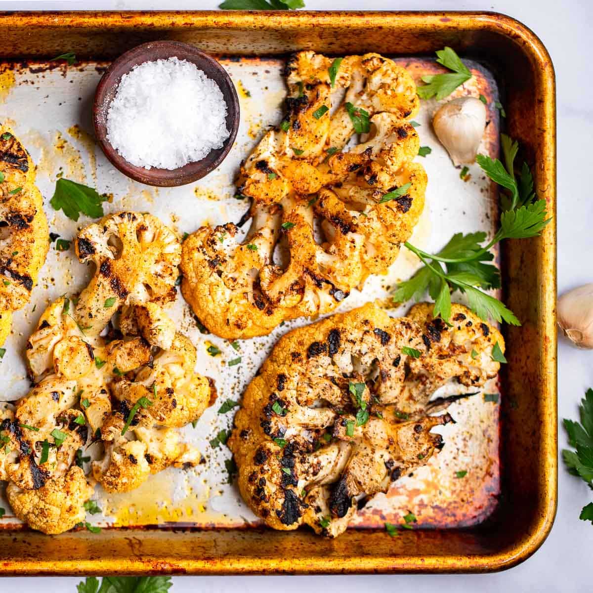 prepared cauliflower steaks on sheet pan