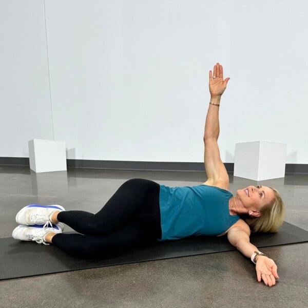 woman doing posture exercises on floor