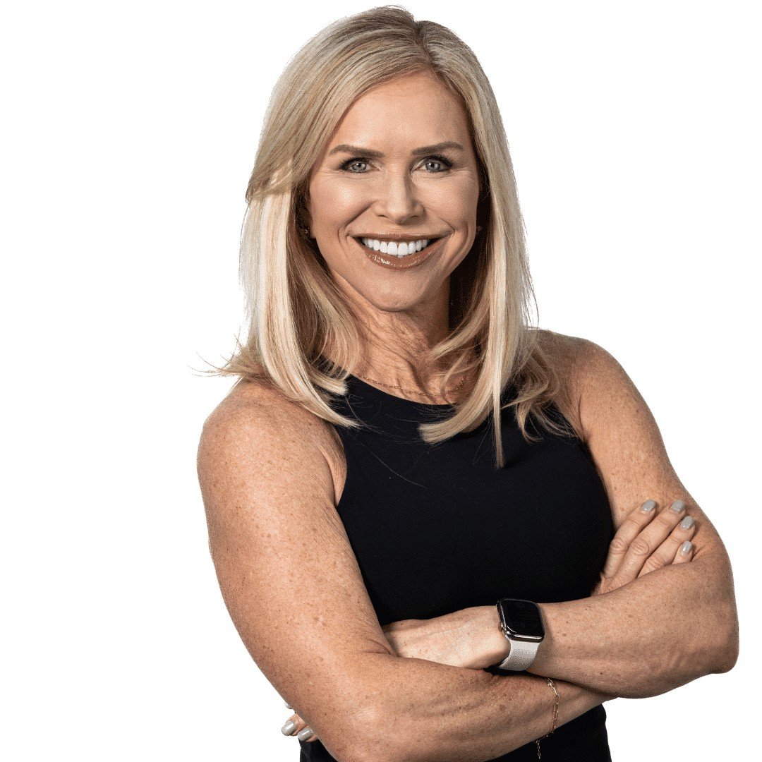 Chris Freytag wearing black tank top, crossing her arms for a fitness photo shoot.