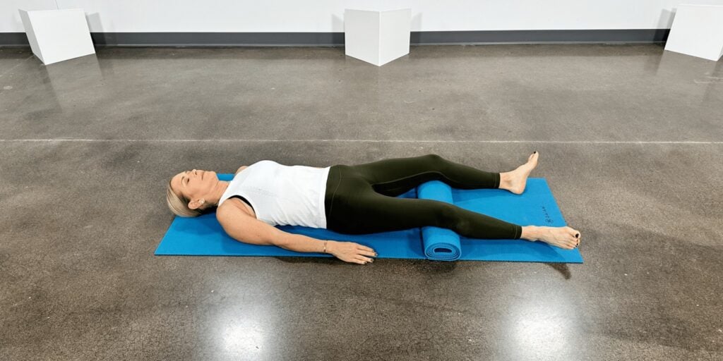 woman doing yoga poses for back pain, final savasana pose