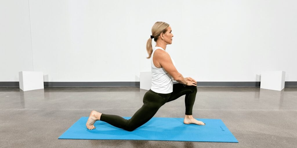 woman doing yoga poses for back pain, crescent lunge on one knee pose