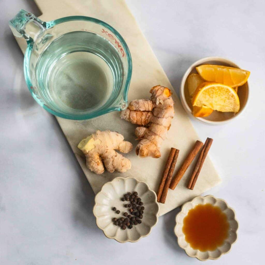 raw ingredients to make ginger turmeric tea on counter