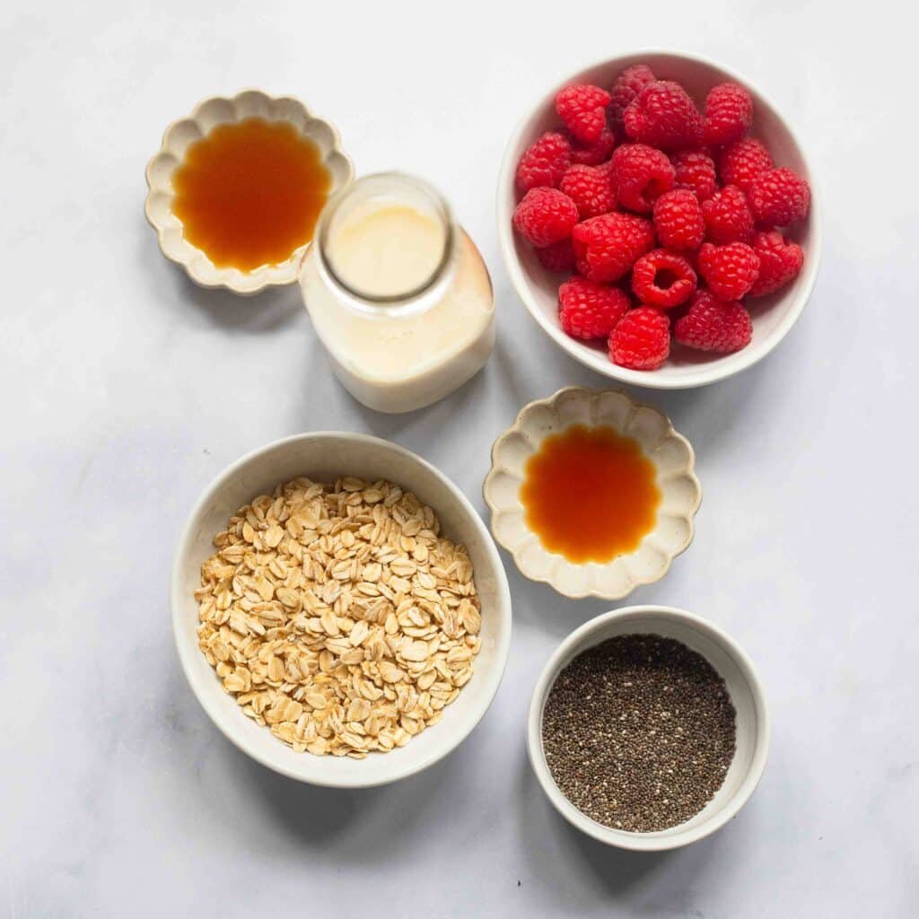 raw ingredients to make vanilla overnight oats on white countertop