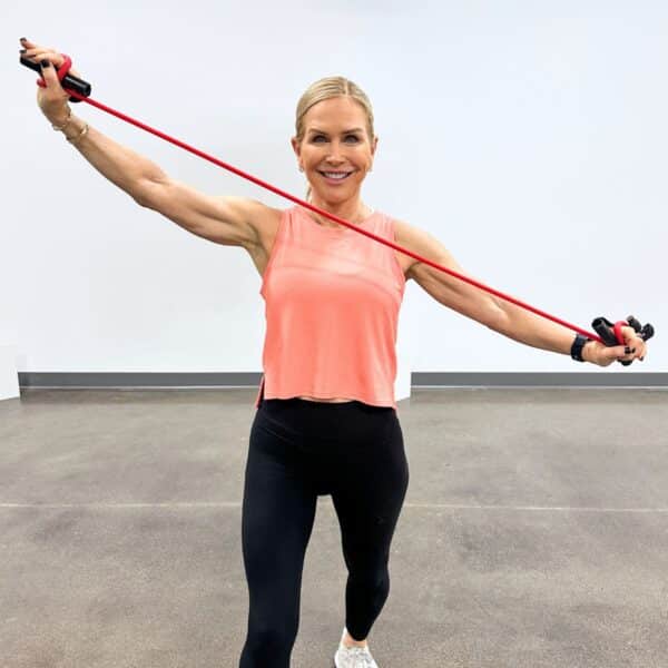 woman showing benefits of resistance bands for home workout