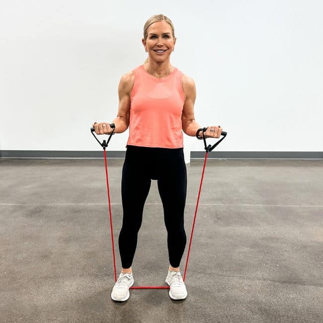 A woman uses a resistance band for mobility exercises