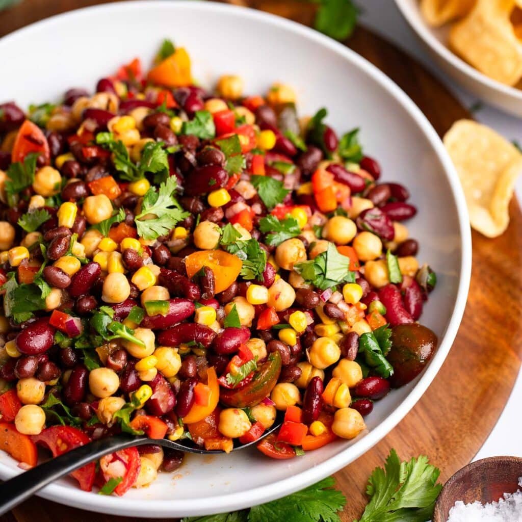 dense bean salad served in white bowl