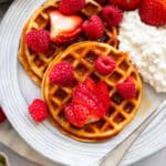 high protein waffles served on plate with strawberries