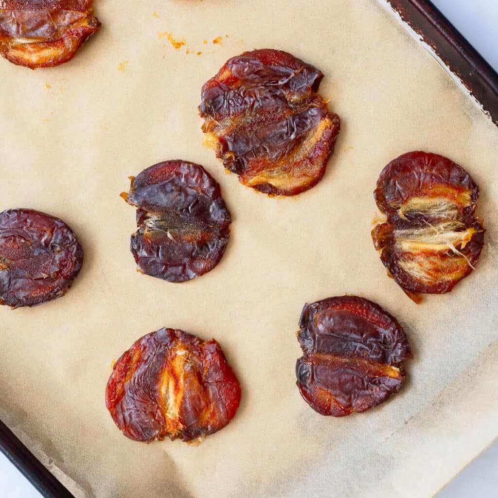 medjool dates smashed on baking sheet