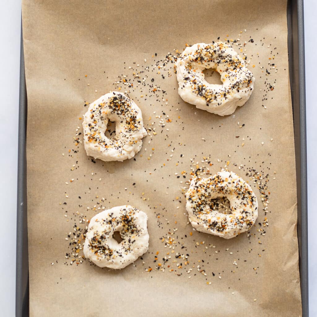 healthy bagels prepped to bake on baking sheet